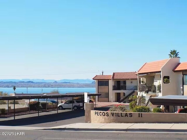 exterior space featuring a water and mountain view