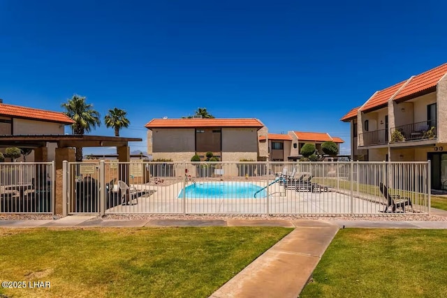 view of pool featuring a patio and a yard