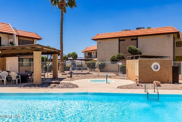 view of pool featuring a patio and a hot tub