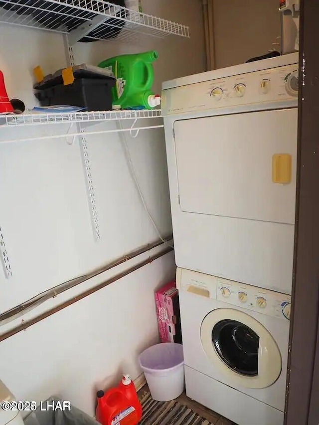 clothes washing area featuring stacked washer / dryer