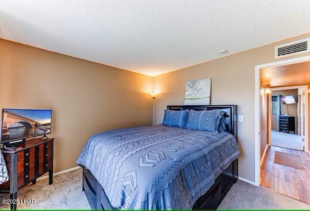 carpeted bedroom featuring a textured ceiling