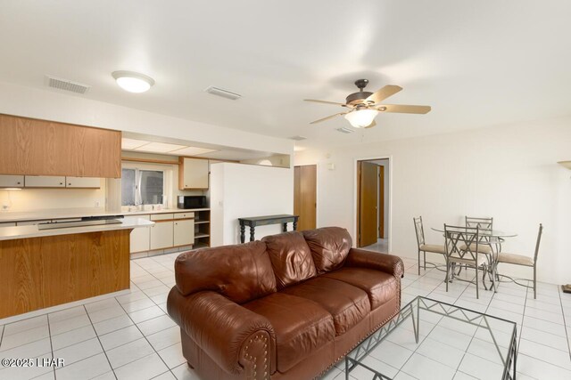 tiled living room featuring ceiling fan