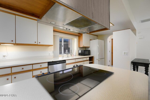 kitchen featuring sink, range, white cabinetry, white refrigerator, and stainless steel dishwasher