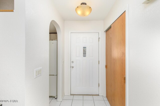 hall with light tile patterned floors