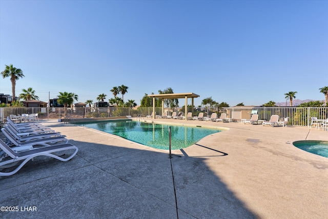 community pool featuring a patio area and fence