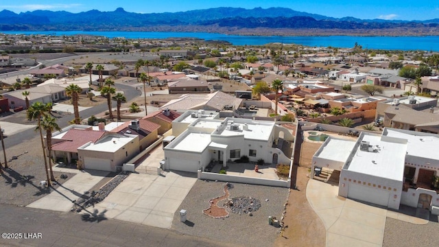 drone / aerial view with a residential view and a water and mountain view