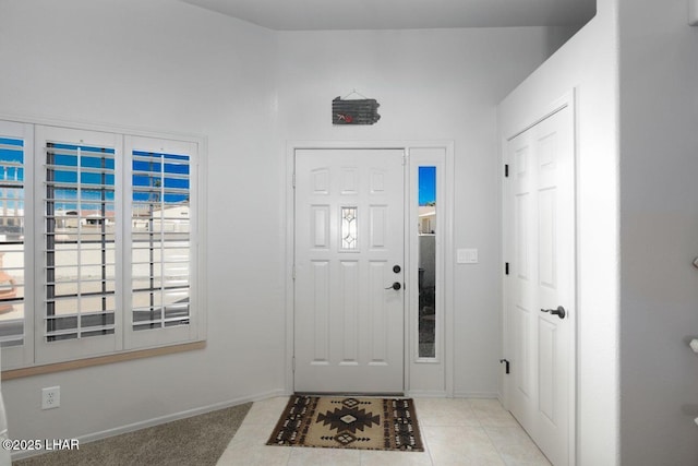 foyer featuring tile patterned flooring and baseboards