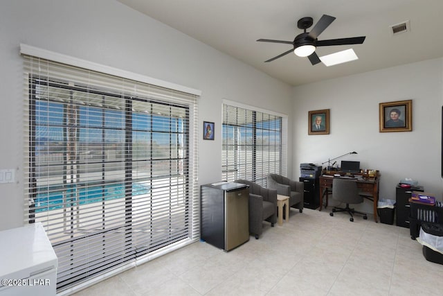 home office with light tile patterned flooring, visible vents, and a ceiling fan