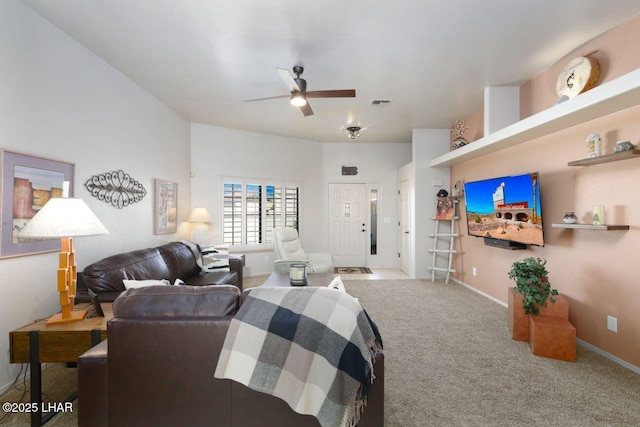 living room featuring baseboards, carpet floors, visible vents, and a ceiling fan