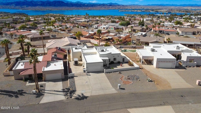 drone / aerial view with a residential view and a water and mountain view