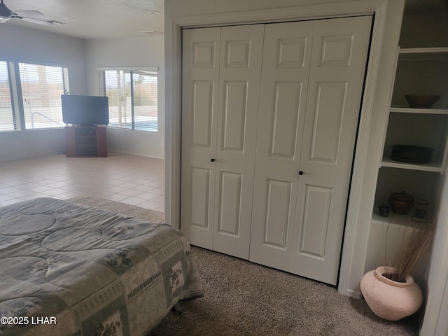 bedroom with a closet and tile patterned floors