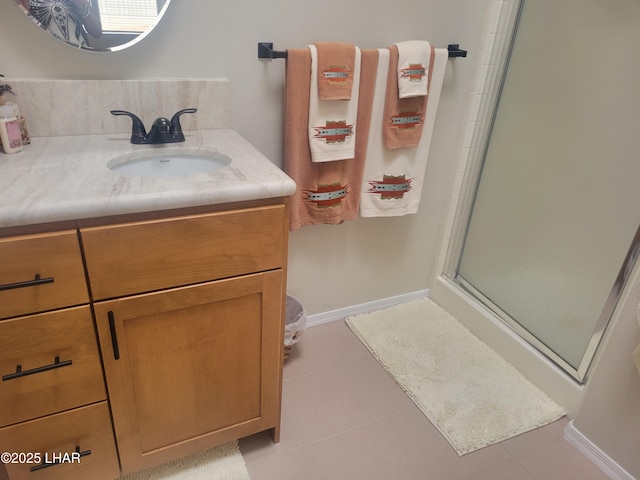 full bath featuring baseboards, a shower stall, and vanity