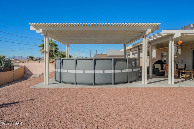 exterior space with a pool and a pergola