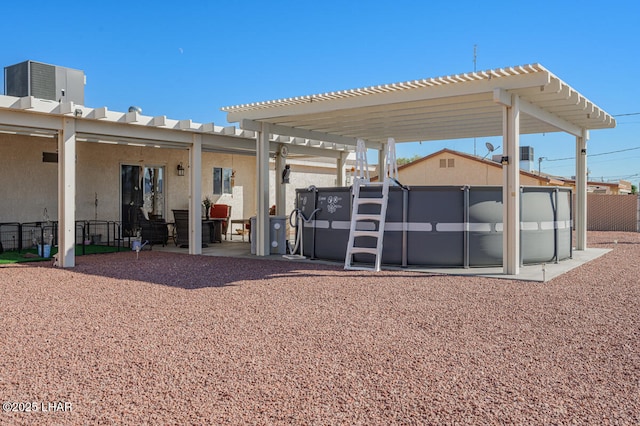 rear view of house with a patio and central AC unit