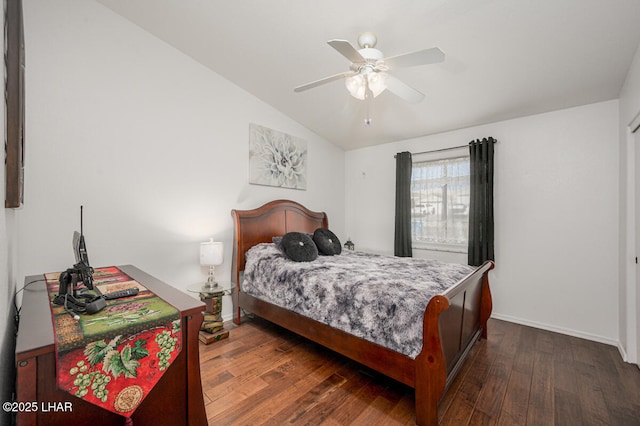 bedroom with ceiling fan, dark hardwood / wood-style floors, and vaulted ceiling