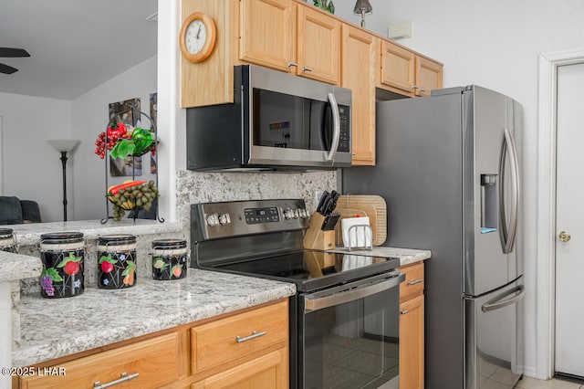 kitchen with light stone counters, backsplash, stainless steel appliances, and light brown cabinets