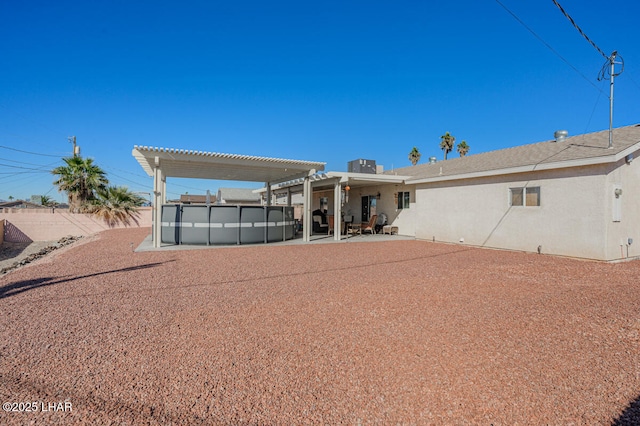 back of property featuring a patio area and a pergola