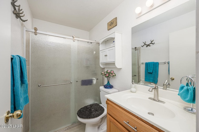 bathroom featuring vanity, toilet, and a shower with door