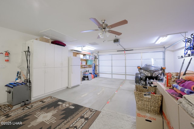 garage featuring a garage door opener, ceiling fan, and white refrigerator