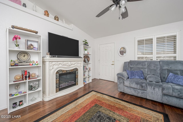 living room featuring ceiling fan, dark hardwood / wood-style flooring, and vaulted ceiling