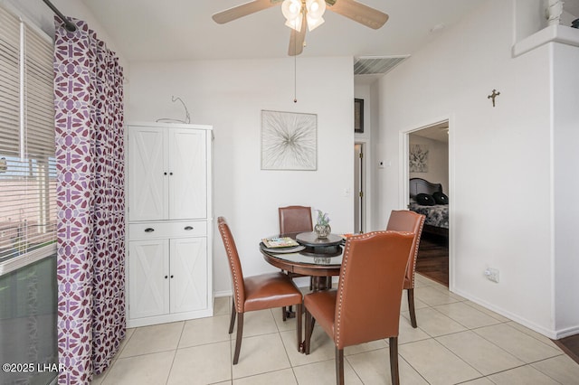 dining space with light tile patterned flooring and ceiling fan