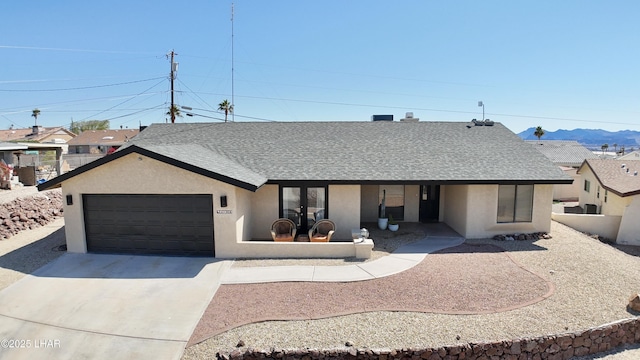 single story home with roof with shingles, stucco siding, concrete driveway, an attached garage, and fence