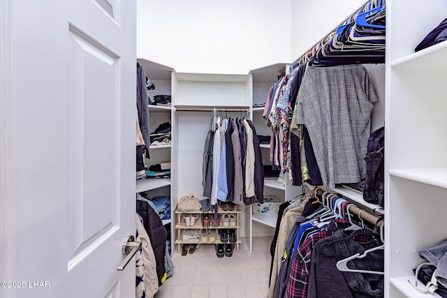 walk in closet with tile patterned flooring