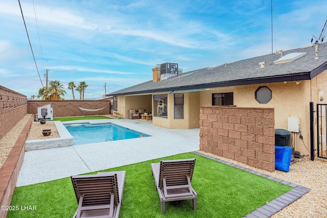 view of pool featuring a fenced in pool, a patio, a lawn, central AC, and a fenced backyard