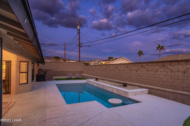 view of swimming pool featuring a fenced in pool, a patio area, and a fenced backyard