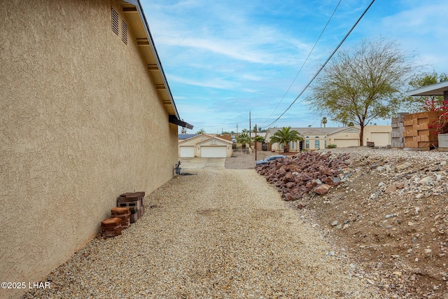 exterior space featuring an outdoor structure and stucco siding