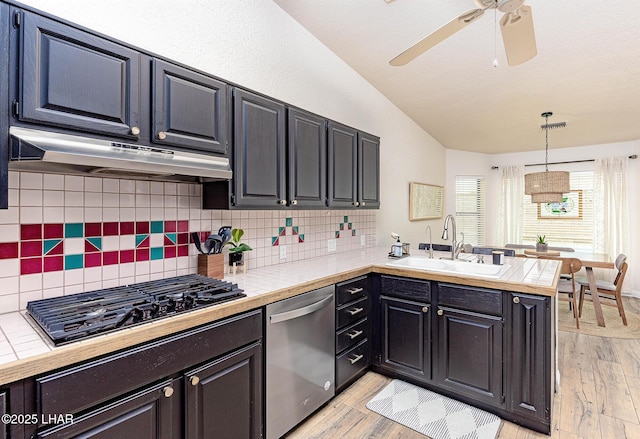 kitchen with black gas stovetop, under cabinet range hood, a peninsula, a sink, and dishwasher