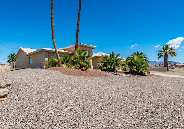 2335 Palo Verde Blvd N, Lake Havasu City, AZ 86404 - view of side of home featuring stucco siding, a tile roof, and fence