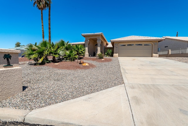 2335 Palo Verde Blvd N, Lake Havasu City, AZ 86404 - mediterranean / spanish house featuring an attached garage, stucco siding, concrete driveway, and a tile roof