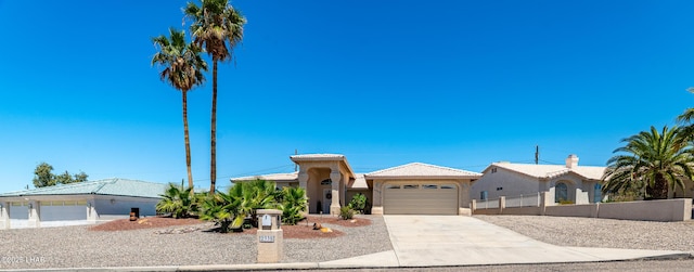 2335 Palo Verde Blvd N, Lake Havasu City, AZ 86404 - view of front of house with an attached garage, concrete driveway, fence, and stucco siding