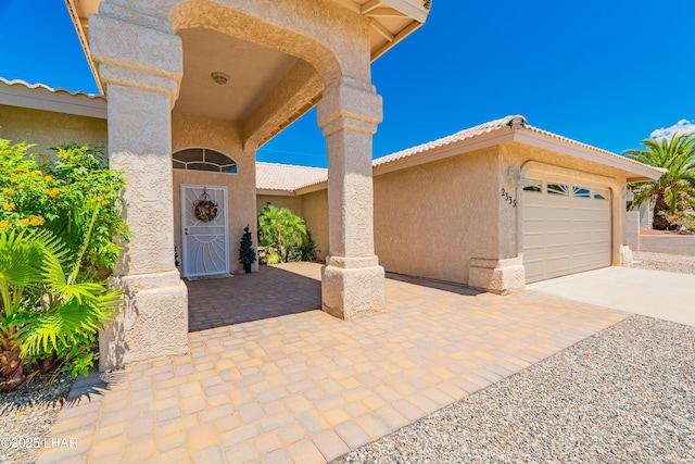 2335 Palo Verde Blvd N, Lake Havasu City, AZ 86404 - doorway to property with stucco siding, driveway, and a garage