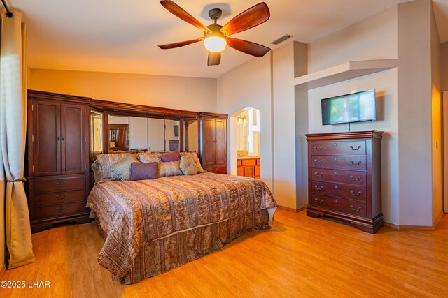 2335 Palo Verde Blvd N, Lake Havasu City, AZ 86404 - bedroom featuring vaulted ceiling, light wood-type flooring, connected bathroom, baseboards, and arched walkways