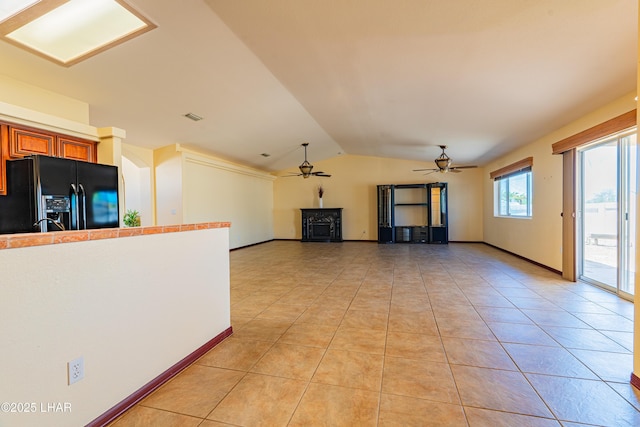 2335 Palo Verde Blvd N, Lake Havasu City, AZ 86404 - unfurnished living room with ceiling fan, vaulted ceiling, light tile patterned floors, and baseboards