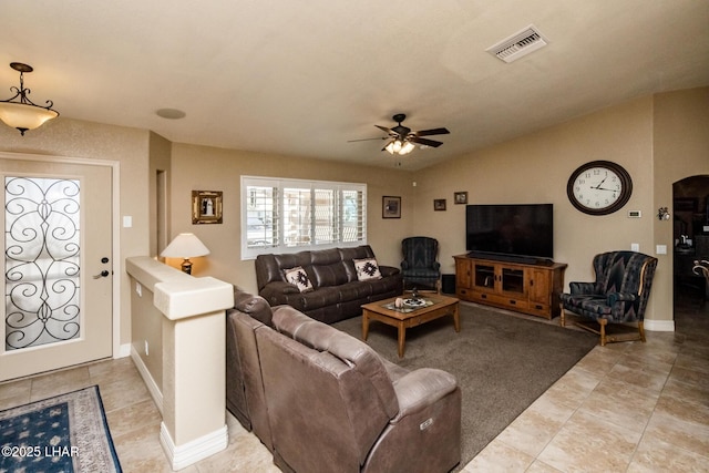 tiled living room featuring ceiling fan and vaulted ceiling