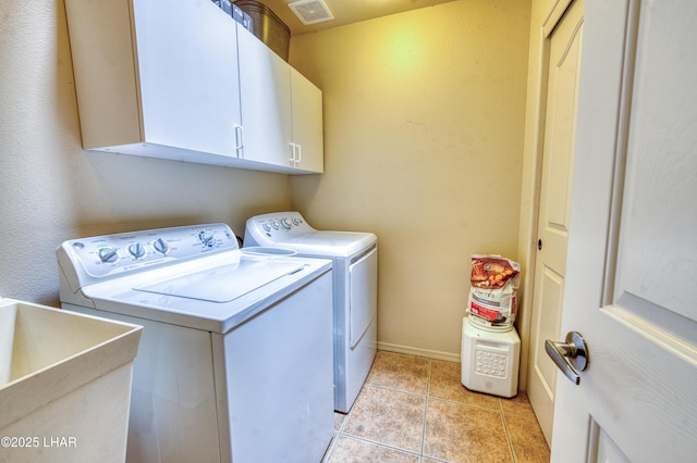3000 Mirage Dr, Lake Havasu City, AZ 86404 - washroom with independent washer and dryer, cabinet space, light tile patterned floors, and baseboards