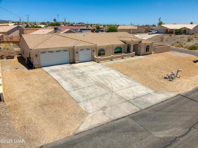 3000 Mirage Dr, Lake Havasu City, AZ 86404 - mediterranean / spanish house featuring an attached garage, driveway, stucco siding, a tile roof, and a residential view