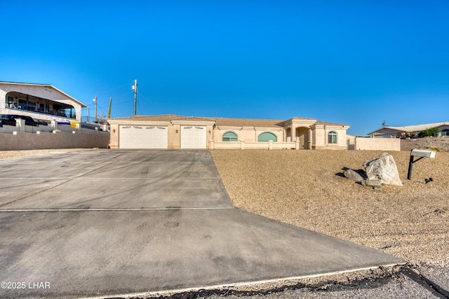 3000 Mirage Dr, Lake Havasu City, AZ 86404 - view of front of house featuring an attached garage, driveway, and stucco siding