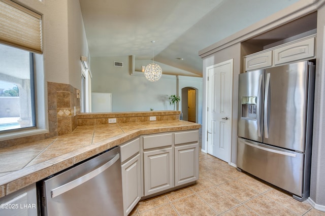 3000 Mirage Dr, Lake Havasu City, AZ 86404 - kitchen with appliances with stainless steel finishes, vaulted ceiling, white cabinets, arched walkways, and light tile patterned floors