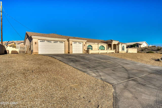 3000 Mirage Dr, Lake Havasu City, AZ 86404 - view of front of house with stucco siding, an attached garage, concrete driveway, and a tiled roof
