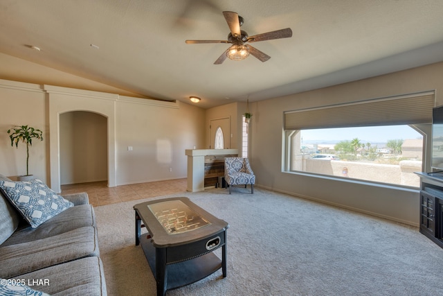 3000 Mirage Dr, Lake Havasu City, AZ 86404 - living room featuring vaulted ceiling, arched walkways, ceiling fan, a fireplace, and carpet flooring