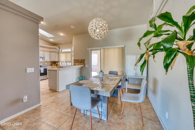 3000 Mirage Dr, Lake Havasu City, AZ 86404 - dining area featuring light tile patterned floors, vaulted ceiling, a textured wall, and baseboards