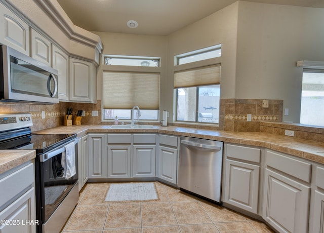 3000 Mirage Dr, Lake Havasu City, AZ 86404 - kitchen featuring appliances with stainless steel finishes, a sink, plenty of natural light, and tasteful backsplash
