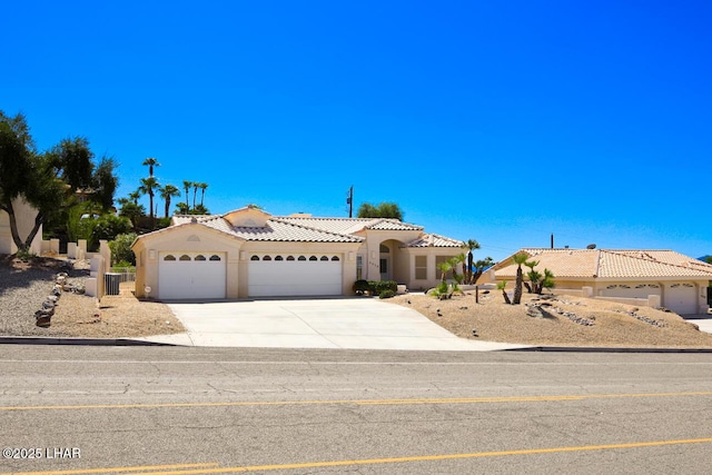 mediterranean / spanish-style home with a garage