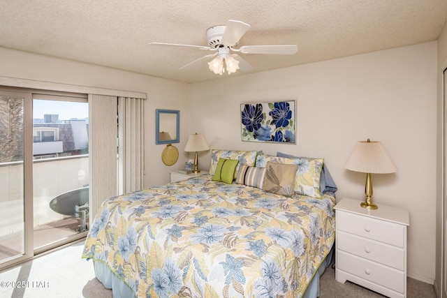 carpeted bedroom with ceiling fan, a textured ceiling, and access to exterior