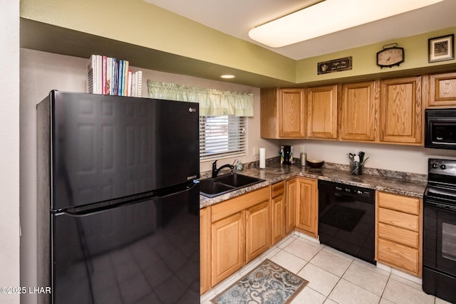 kitchen with black appliances, light tile patterned floors, dark countertops, and a sink