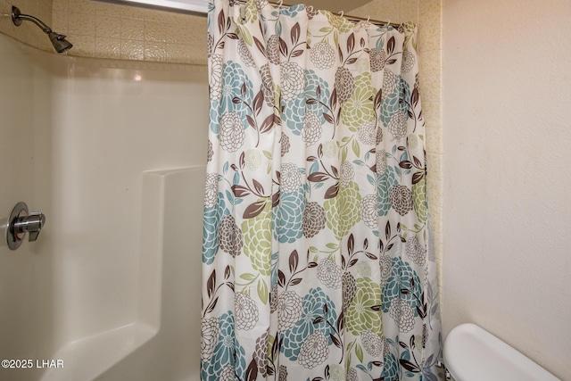 bathroom featuring toilet and a shower with curtain